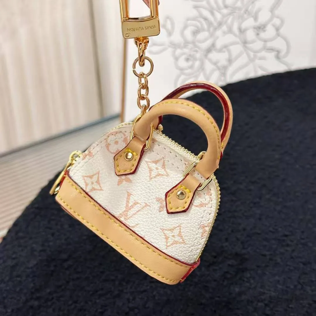 M01883 Micro Alma Bag Charm Monogram Dune Coated Canvas