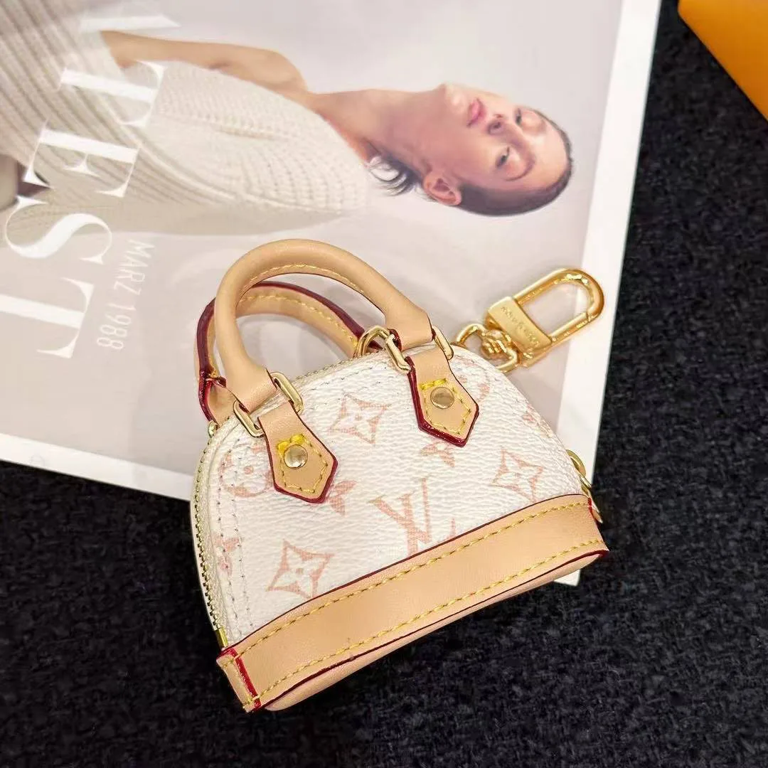 M01883 Micro Alma Bag Charm Monogram Dune Coated Canvas