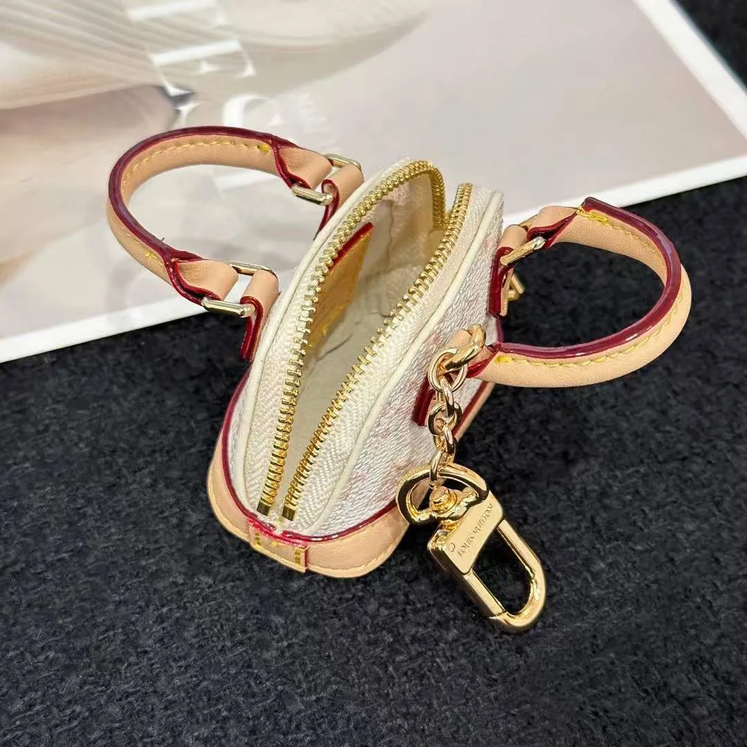 M01883 Micro Alma Bag Charm Monogram Dune Coated Canvas