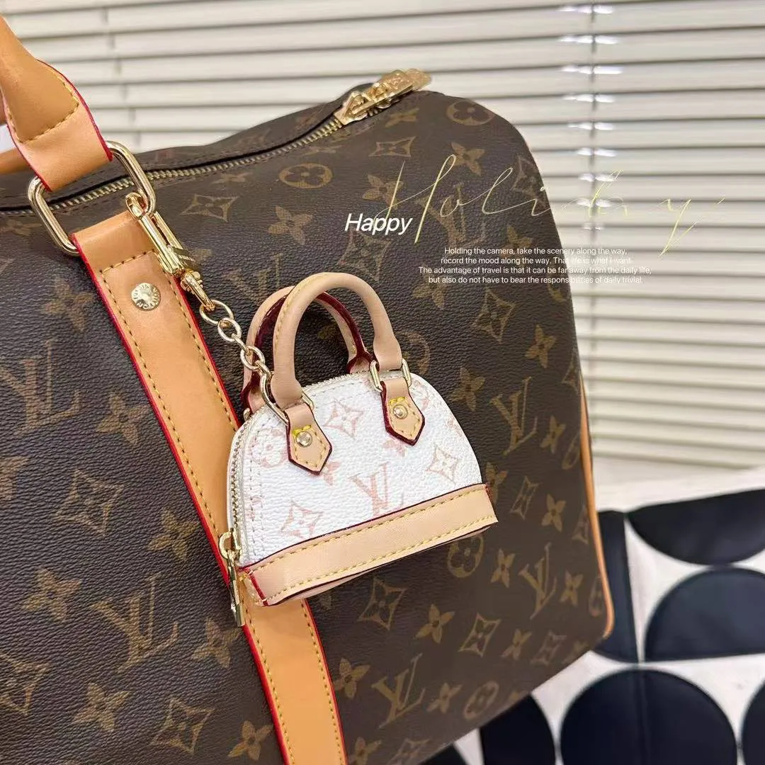 M01883 Micro Alma Bag Charm Monogram Dune Coated Canvas